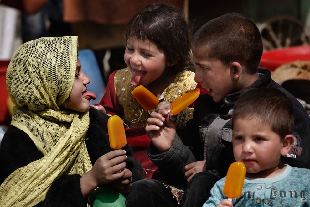 Afghani kids eating popsicles
